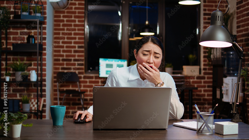 Poster employee tired while writing emails at computer desk, trying to freshen up by drinking coffee. exhau