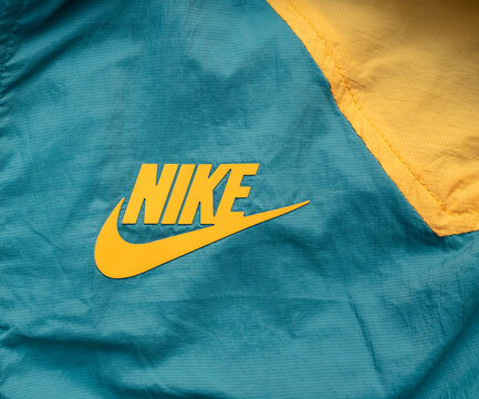 Kyiv, Ukraine - September 24, 2024: Nike Sportswear clothes brand logo on the yellow wind breaker