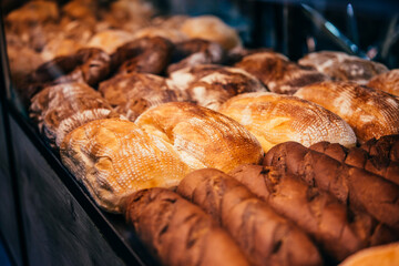 Different kinds of fresh bread on sale at a bakery of cafe.
