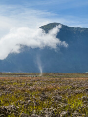 Dust Devil, Bromo Tengger Semeru National Park including farm land in the foreground.