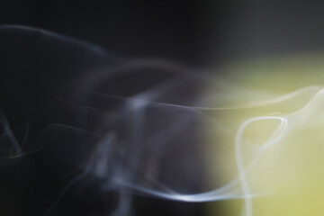 Smoke from the cigarette has a higher temperature than the surrounding giving it lower density which makes it rise