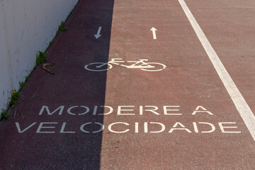 Bike lane showing moderate the speed sign in portuguese language