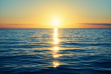 Obraz premium A breathtaking sunrise over a serene ocean with sparkling water reflections under a clear sky.