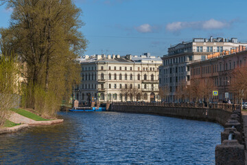 Naklejka premium Moika River embankment along New Holland and the building of the Museum and Exhibition Center St. Petersburg Artist on a sunny spring morning, Saint Petersburg, Russia