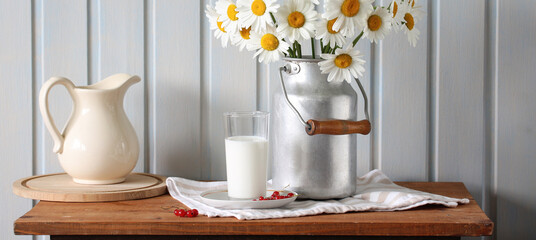 summer still life with daisies, red currants and a glass of milk. flowers and berries.