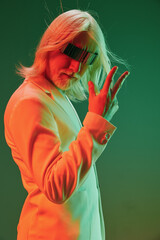 Futuristic man posing confidently with stylish glasses, vibrant colored background, showcasing...
