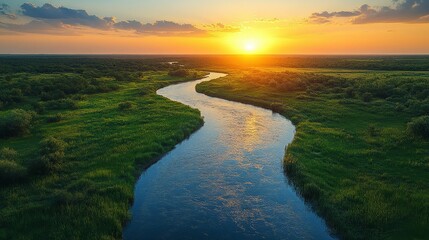 Fototapeta premium River at Sunset with Green Grass and Golden Sky