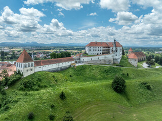 Aerial view of Ptuj castle with red roof gothic renaissance palace building, bastions, towers on a...