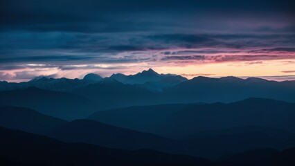Fototapeta premium Mountain Silhouette at Dawn: The dark silhouette of a mountain range with a vibrant sky transitioning from deep blue to the first light of dawn.