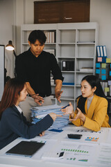 Financial analysts analyze business financial reports on a digital tablet planning investment project during a discussion at a meeting of corporate showing the results of their successful teamwork.