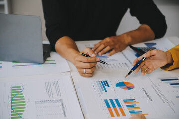 Financial analysts analyze business financial reports on a digital tablet planning investment project during a discussion at a meeting of corporate showing the results of their successful teamwork.