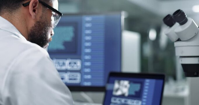 Scientist, laptop and lab analysis for research, biotechnology and man recording or live imaging results. Medical worker, science and innovation or bacteria study, data documenting and microbiologist