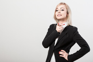 Obraz premium Confident businesswoman pointing with finger on white background