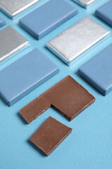 Blue chocolate bars on a blue background