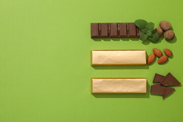 Chocolate bars with almonds and mint leaves