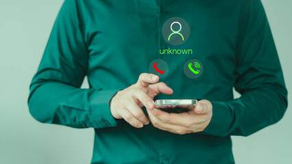 Concept of scam, fraud with a mobile phone from the criminal. Man answering the incoming call. Phone call was from an unknown number. Call center gang or stranger. Hoax person with a fake identity.