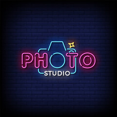photo studio neon sign vector with brick wall background 