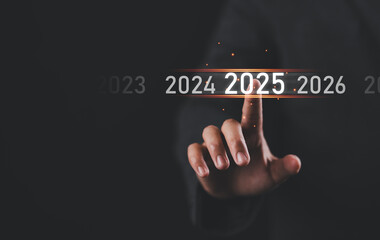 Happy New Year 2025, Hand touch on a virtual screen 2025, New Goals, Plans, and numbers for Next Year, Businessman touching future growth year 2024 to 2025, Planning, opportunity, business strategy.