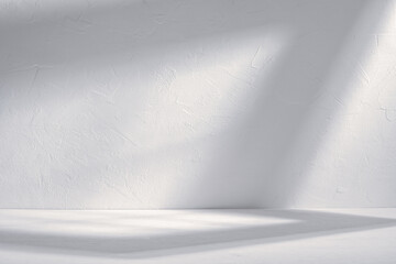 Soft light and shadows on background with white wall and tabletop early in morning in minimalist space.