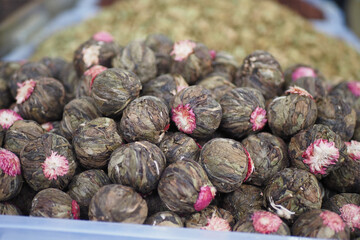 A closeup view of unique and vibrant herbal buds displayed at the market for sale