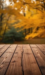 Fototapeta premium empty wooden table with autumn leaves on the background