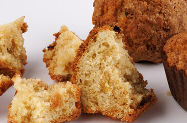 Muffin and muffin pieces on a white background.