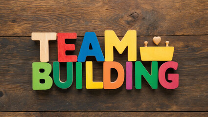 team building word colorful wooden letters on plain white background