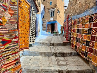 Chefchaouen, Morocco: Blue narow stairs with colourful walls and flowerpots into old walled city, or medina, North Africa travel destination