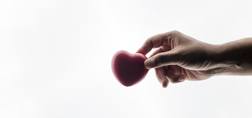 Adult hands giving a red heart, health care, organ donation, family life insurance, world heart day, world health day, praying concept