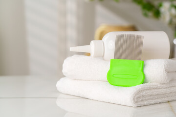Bottles of Lice Treatment Products and a Comb on a Countertop