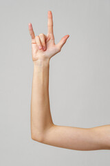 A Woman's Arm Making a Rock On Hand Gesture