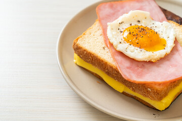 bread toasted cheese topped ham and fried egg with pork sausage