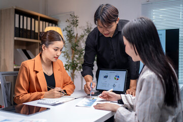 Businesspeople having a discussion about marketing strategy, working together as a team in boardroom
