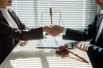 Businesspeople shaking hands after signing contract in law office