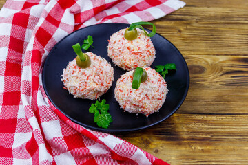 Appetizer of crab-cheese balls made in a shape of Christmas baubles on wooden table