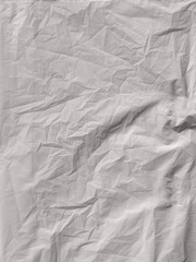 The surface of the white plastic bag has wrinkles and crumples. Poor condition, recycled blank sheet of plastic bag and blank space for text.