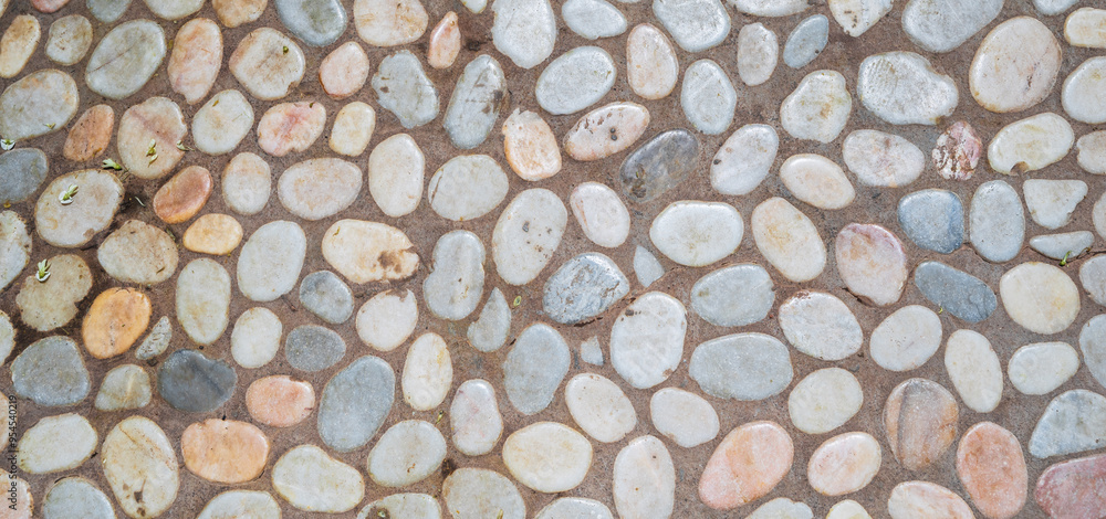 Wall mural Detailed close-up of a white pebble path lined with stone. Horizontal background