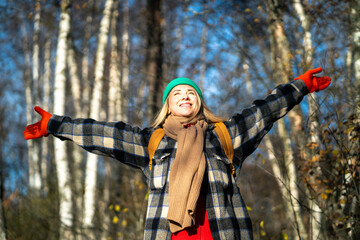 Joyful woman have trip with backpack raised arms feeling happiness, freedom in autumn forest...