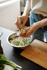 Female hands making stuffed bell peppers