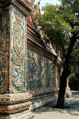 Colorful Mosaic Wall and Tree at Buddhist Temple in Thailand