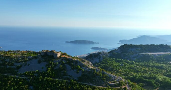 Drone shot passing the Fort Kosmac toward the Bečići city, summer in Montenegro