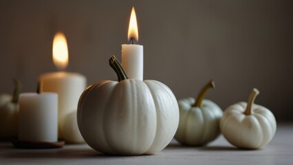 White pumpkin for Halloween with white candles on a white background