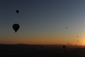 Beautiful view of hot air balloons floating in the air at sunrise with clear sky in Cappadocia, Turkey (Türkiye)