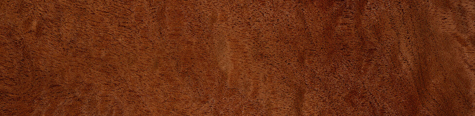Pommele mahogany veneer with intricate swirling patterns and deep copper tones