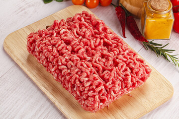 Raw minced beef meat over board