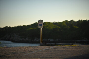 Reserved handycap parking sign on sunset