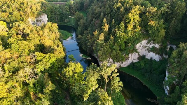 Aerial footage of flight over the rocky valley of the Danube River near Sigmaringen at sunset