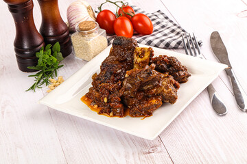 Prepared tasty beef ribs with sauce