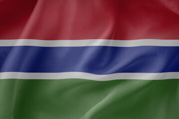 Fototapeta premium Gambia waving flag close up fabric texture background