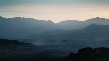 desert with rocky mountains and sky with clouds in the evening in Egypt